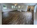 Open-concept living room featuring LVP floors and seamless flow to the modern kitchen at 849 Laurelridge Ct, Brooksville, FL 34601