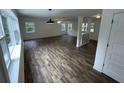 Spacious living room with luxury vinyl flooring and abundant natural light from large windows at 849 Laurelridge Ct, Brooksville, FL 34601