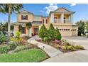 Inviting two-story house features lush landscaping, a charming walkway, and a convenient two-car garage at 19300 Lonesome Pine Dr, Land O Lakes, FL 34638