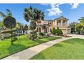 Charming two-story home boasts a manicured lawn, beautiful landscaping, and a well-maintained walkway at 19300 Lonesome Pine Dr, Land O Lakes, FL 34638