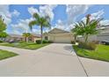 Well-maintained house with a driveway and attractive landscaping at 16903 Peaceful Valley Dr, Wimauma, FL 33598