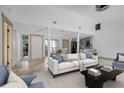 Bright and airy living room with modern sofa and decor at 2312 Southern Lites Ave, Lutz, FL 33549