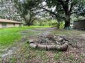 Firepit in a spacious backyard with mature trees at 19323 Fort Dade, Brooksville, FL 34601