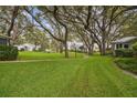 Landscaped community grounds with mature trees and walking paths at 4137 Edgewood Dr, Holiday, FL 34691