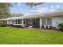 Spacious backyard with lush grass and screened patio at 4137 Edgewood Dr, Holiday, FL 34691