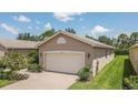Single-story home with attached garage and landscaped yard at 16252 Amethyst Key Dr, Wimauma, FL 33598