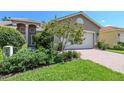 Two-story house with a brick driveway and lush landscaping at 16252 Amethyst Key Dr, Wimauma, FL 33598