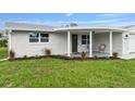 Charming ranch-style home with covered porch at 2624 Society Dr, Holiday, FL 34691