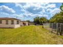 Large backyard with grassy area at 4902 N Habana Ave, Tampa, FL 33614