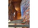 Interior view of a unique wooden stairwell with brick chimney feature at 4904 N Habana Ave, Tampa, FL 33614