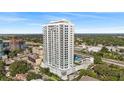 Aerial view of a modern highrise building near a highway and other buildings at 2910 W Barcelona St # 903, Tampa, FL 33629