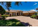 Two-story home with a brick driveway and two car garage at 225 Pesaro Dr, North Venice, FL 34275