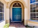 Elegant entryway with a teal double door and arched entry at 225 Pesaro Dr, North Venice, FL 34275