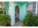 Front entrance of a teal building with plants and walkway at 4214 Prince Pl, New Port Richey, FL 34652