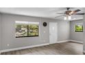 Bright living room with wood-look floors and ceiling fan at 11702 Raintree Village Blvd # A, Temple Terrace, FL 33617
