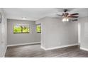 Spacious living room with ceiling fan and large window at 11702 Raintree Village Blvd # A, Temple Terrace, FL 33617