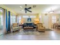 Living room with hardwood floors, seating, and access to patio at 1940 Inverness Greens Dr # 1940, Sun City Center, FL 33573