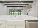 Modern kitchen features a farmhouse sink, quartz countertops, and stainless steel appliances at 149 Hidden Estates Ct, Brandon, FL 33511