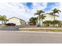 Two-story building with a shared parking area and tropical landscaping at 6504 Abaco Dr # 101, Apollo Beach, FL 33572