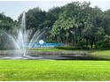 Lake Bernadette entrance with fountain and lush landscaping at 35226 Janine Dr, Zephyrhills, FL 33541