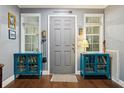 Inviting entryway with hardwood floors and teal cabinets at 7029 Dormany Loop, Plant City, FL 33565