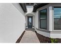 Bright entryway with tile flooring and a modern front door at 1871 Pepper Grass Dr, North Port, FL 34289