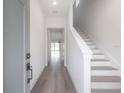 Bright and airy entryway with hardwood floors and staircase at 5530 N 9Th St # 5, Tampa, FL 33604