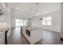 Open-concept kitchen has an island, sleek appliances, and contemporary finishes at 5530 N 9Th St # 5, Tampa, FL 33604
