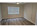 Bedroom with wood-look flooring and window blinds at 11655 3Rd E St # 1, Treasure Island, FL 33706