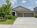 Two-story house with three-car garage at 5474 Leslie Canyon Dr, Wimauma, FL 33598