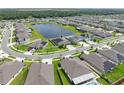 Aerial view of a house with solar panels, showcasing the property and surrounding neighborhood at 5474 Leslie Canyon Dr, Wimauma, FL 33598