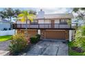 Two-story house with double garage and manicured landscaping at 9408 Oak St, Riverview, FL 33578