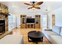 Living room with stone fireplace, built-in shelving, and comfy sofas at 9408 Oak St, Riverview, FL 33578
