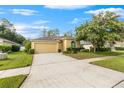 Single-story house with attached garage and manicured lawn at 35506 Wickingham Ct, Zephyrhills, FL 33541