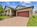 Single-Gathering home with brick driveway, two-car garage and palm trees at 10012 Sage Creek Dr, Ruskin, FL 33573