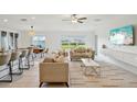Bright living room with sofas, a large TV, and access to the kitchen at 13265 Great Plains Dr, Riverview, FL 33579