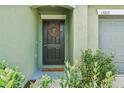 Dark brown front door with a welcome mat and greenery on either side at 13265 Great Plains Dr, Riverview, FL 33579