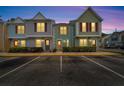 Row of townhouses at night with lights on at 3364 W Wyoming Cir, Tampa, FL 33611