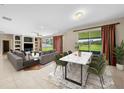 Open living space with hardwood floors, a dining area, and access to the backyard at 212 Excalibur Ct, Brandon, FL 33511