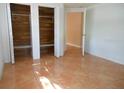 Simple bedroom with tile floors and double closets at 7101 Green St, New Port Richey, FL 34652