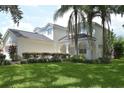 Two-story house with white siding, lush landscaping, and a large yard at 5308 Cedarshake Ln, Valrico, FL 33596