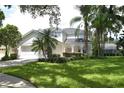 Two-story house with white siding, lush landscaping, and a large yard at 5308 Cedarshake Ln, Valrico, FL 33596