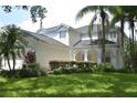 Two-story house with white siding, lush landscaping, and a large yard at 5308 Cedarshake Ln, Valrico, FL 33596