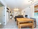 Bright dining area with a farmhouse table and bench seating at 4622 Paloverde Dr, New Port Richey, FL 34652