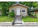 Tan house with white door and steps at 405 E Dr Martin Luther King Jr Blvd, Tampa, FL 33603
