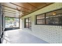 Cozy screened-in porch with tiled floor and ceiling fan at 7024 Filbert Ln, Tampa, FL 33637