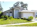 Inviting single-Gathering home with mature trees, lush landscaping, and manicured lawn at 13451 Knotty Ln, Hudson, FL 34669