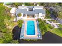 Aerial view of community pool, building, and lush landscaping at 758 Pine Run Dr # 758, Osprey, FL 34229