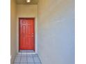 Red front door entry into the home with tiled flooring at 633 Tremont Greens Ln # 16, Sun City Center, FL 33573