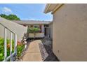 Private courtyard entry with a walkway and tropical plants at 633 Tremont Greens Ln # 16, Sun City Center, FL 33573